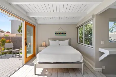 a bedroom with a bed and a balcony at Bird Rock Dreams - Ocean Views, Massive Yard, Outdoor Dining, Fast Wifi & AC! in San Diego