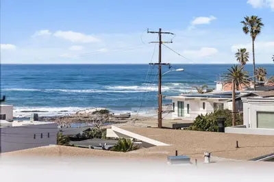 a view of the ocean from the roof of a house at Bird Rock Dreams - Ocean Views, Massive Yard, Outdoor Dining, Fast Wifi & AC! in San Diego
