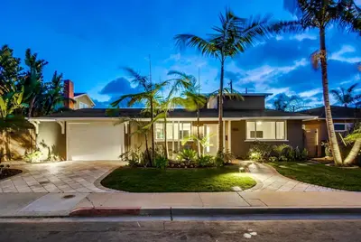 a house with palm trees and a driveway at Bird Rock Dreams - Ocean Views, Massive Yard, Outdoor Dining, Fast Wifi & AC! in San Diego