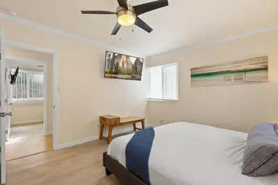 a bedroom with a bed and a ceiling fan at WindnSea Beach Perfection - Walk2Beach, Pet Friendly & Parking in San Diego