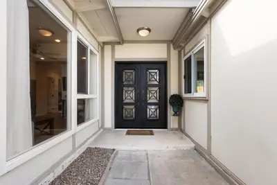 a front door of a house with a potted plant at WindnSea Beach Perfection - Walk2Beach, Pet Friendly & Parking in San Diego