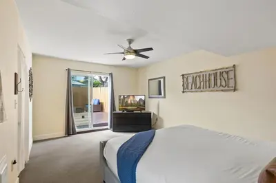 a bedroom with a bed and a ceiling fan at WindnSea Beach Perfection - Walk2Beach, Pet Friendly & Parking in San Diego
