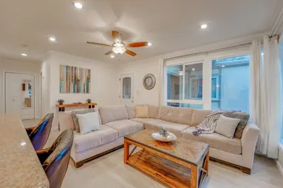 a living room with a couch and a table at WindnSea Beach Perfection - Walk2Beach, Pet Friendly & Parking in San Diego