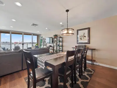 a dining room with a table and chairs at Stunning Bayfront condo with gorgeous views, garage, massive roof deck & AC - dogs welcome! in San Diego