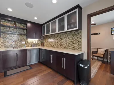 a kitchen with dark wood cabinets and a counter at Stunning Bayfront condo with gorgeous views, garage, massive roof deck & AC - dogs welcome! in San Diego