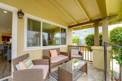 a porch with wicker chairs and a table at La Jolla Oasis - Pet Friendly, Large Backyard, Walk2Beach & Location! in San Diego
