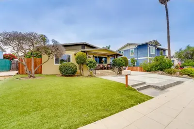 a house with a lawn in front of it at La Jolla Oasis - Pet Friendly, Large Backyard, Walk2Beach & Location! in San Diego