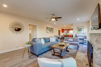a living room with a blue couch and a table at La Jolla Oasis - Pet Friendly, Large Backyard, Walk2Beach & Location! in San Diego