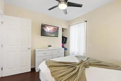 a bedroom with a bed with a ceiling fan at Riviera Bay View Dream - Private patio with bay view and parking in San Diego