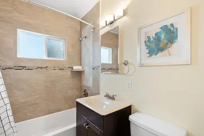 a bathroom with a sink and a toilet and a mirror at Riviera Bay View Dream - Private patio with bay view and parking in San Diego