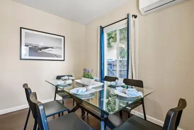 a dining room with a glass table and chairs at Riviera Bay View Dream - Private patio with bay view and parking in San Diego