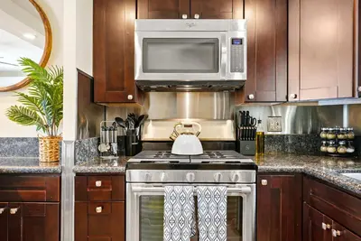a kitchen with a stove and a microwave at Riviera Bay View Dream - Private patio with bay view and parking in San Diego
