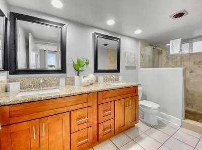 a bathroom with two sinks and a toilet and a shower at Oceanfront Condo with Front Patio, Gas Grill, Fire Pit - Prime Location!! in San Diego