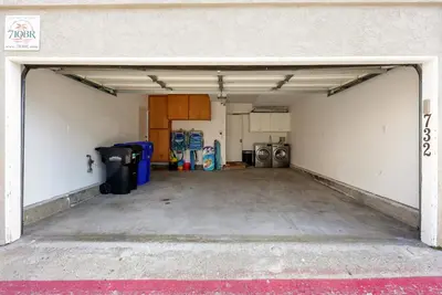 an empty garage with a garage door open at Stunning Beach Home with Fireplace, Fast WiFi, Grill & Outdoor Seating! in San Diego