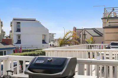 a barbecue grill sitting on a white fence at Stunning Beach Home with Fireplace, Fast WiFi, Grill & Outdoor Seating! in San Diego