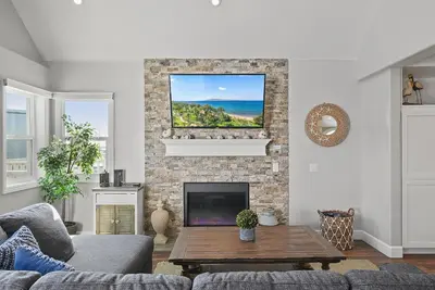 a living room with a couch and a fireplace at Stunning Beach Home with Fireplace, Fast WiFi, Grill & Outdoor Seating! in San Diego