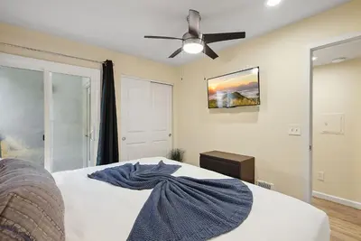 a bedroom with a bed with a ceiling fan at Beach Perfection - Ocean Views, Parking, Pet Friendly & Steps2Sand in San Diego
