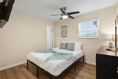 a bedroom with a bed with a ceiling fan at Beach Perfection - Ocean Views, Parking, Pet Friendly & Steps2Sand in San Diego