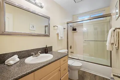 a bathroom with a sink and a toilet and a shower at Beach Perfection - Ocean Views, Parking, Pet Friendly & Steps2Sand in San Diego