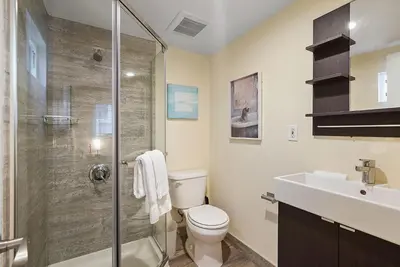 a bathroom with a shower and a toilet and a sink at Beach Perfection - Ocean Views, Parking, Pet Friendly & Steps2Sand in San Diego
