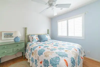 a bedroom with a bed and a ceiling fan at Bayfront Paradise- Bay Views & Boardwalk Patio in San Diego