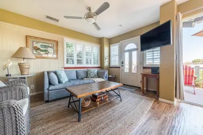 a living room with a couch and a table at Bayfront Paradise- Bay Views & Boardwalk Patio in San Diego