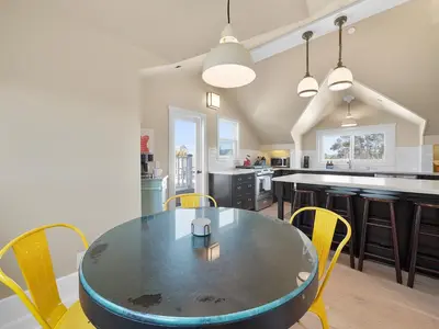 a kitchen and dining room with a table and chairs at Kennebeck Views - Ocean View, Roof Patio, Steps to Beach & Boardwalk in San Diego