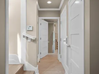 a hallway with white walls and a white door at Kennebeck Views - Ocean View, Roof Patio, Steps to Beach & Boardwalk in San Diego