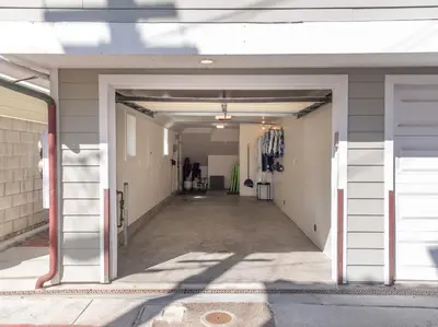 an empty hallway of a building with a person in the distance at Kennebeck Views - Ocean View, Roof Patio, Steps to Beach & Boardwalk in San Diego