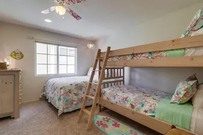 a bedroom with two bunk beds and a ladder at Bayfront Dream - Bay Views, Rooftop Patio, & Garage! in San Diego