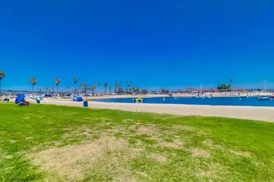 a park with a beach and a body of water at Bayfront Dream - Bay Views, Rooftop Patio, & Garage! in San Diego