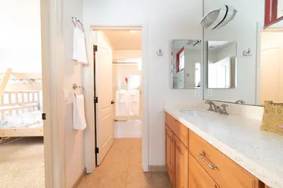 a bathroom with a sink and a mirror at Bayfront Dream - Bay Views, Rooftop Patio, & Garage! in San Diego