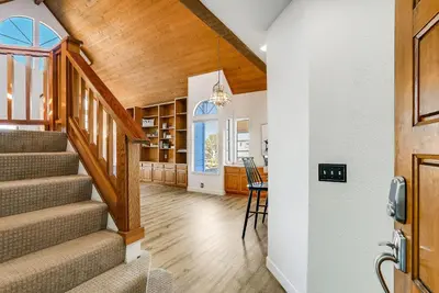 a staircase in a home with a wooden ceiling at Ormond Retreat w Ocean View, Steps2beach & Garage in San Diego