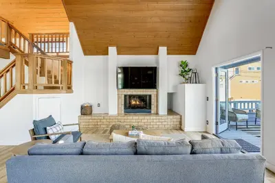 a living room with a couch and a fireplace at Ormond Retreat w Ocean View, Steps2beach & Garage in San Diego