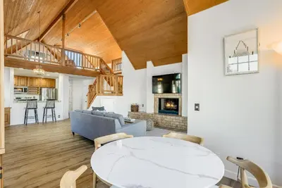 a living room with a table and a couch at Ormond Retreat w Ocean View, Steps2beach & Garage in San Diego