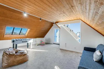 a living room with a wooden ceiling and a ping pong table at Ormond Retreat w Ocean View, Steps2beach & Garage in San Diego
