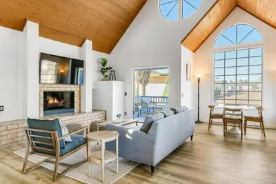 a living room with a couch and a fireplace at Ormond Retreat w Ocean View, Steps2beach & Garage in San Diego