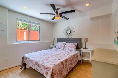 a bedroom with a bed and a ceiling fan at Beach Oasis - Rooftop, Steps2Sand and Water Views in San Diego