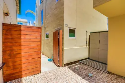 a wooden fence in front of a building at Beach Oasis - Rooftop, Steps2Sand and Water Views in San Diego