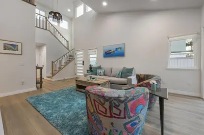 a living room with a couch and a table at Modern Dream Home - Fire Pit, Grill, Large Yard & AC in Encinitas