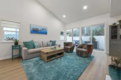 a living room with a couch and two chairs at Modern Dream Home - Fire Pit, Grill, Large Yard & AC in Encinitas