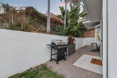 a grill in the backyard of a house at Modern Dream Home - Fire Pit, Grill, Large Yard & AC in Encinitas