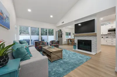 a living room with a couch and a fireplace at Modern Dream Home - Fire Pit, Grill, Large Yard & AC in Encinitas