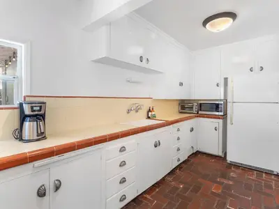 a kitchen with white cabinets and a white refrigerator at La Jolla Ocean Dream - Walk 2 Beach - Dog Friendly in San Diego