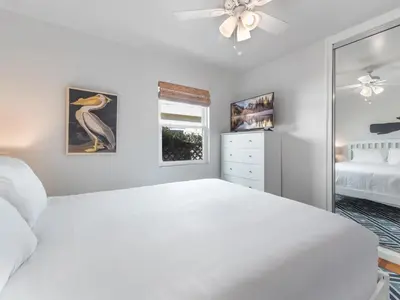 a white bedroom with a bed and a window at La Jolla Ocean Dream - Walk 2 Beach - Dog Friendly in San Diego