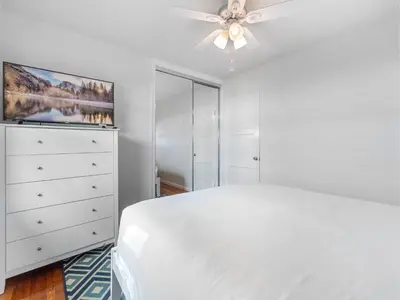 a white bedroom with a bed and a ceiling fan at La Jolla Ocean Dream - Walk 2 Beach - Dog Friendly in San Diego