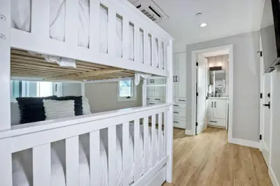 a white hallway with white walls and wooden floors at Luxury Ocean Oasis 3BR I Balcony I Firepit in San Diego