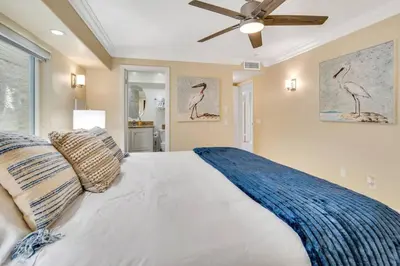 a bedroom with a large bed with a ceiling fan at Oceanfront Home with Stunning View in Oceanside
