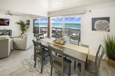 a dining room with a table and chairs and the ocean at Oceanfront Home with Stunning View in Oceanside