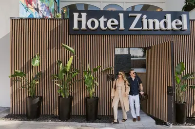 a man and woman standing in front of a hotel ziggurat at Hotel Zindel in San Diego